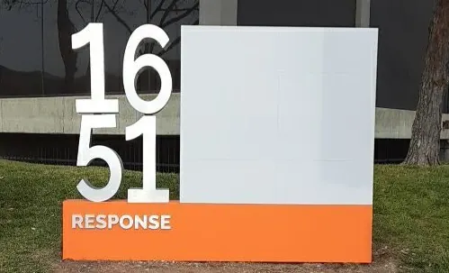 Front view of the 1651 Response Road monument with stacked silver-white numerals and an orange base