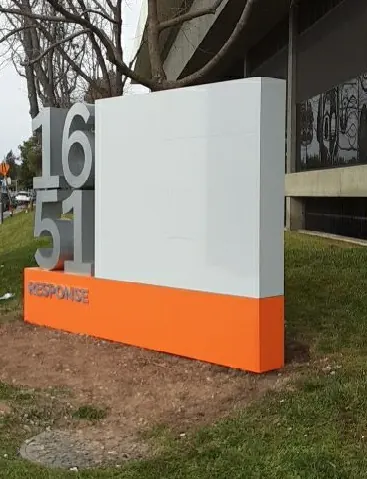 Side view of the monument showing the depth of the dimensional address numbers against the white cabinet